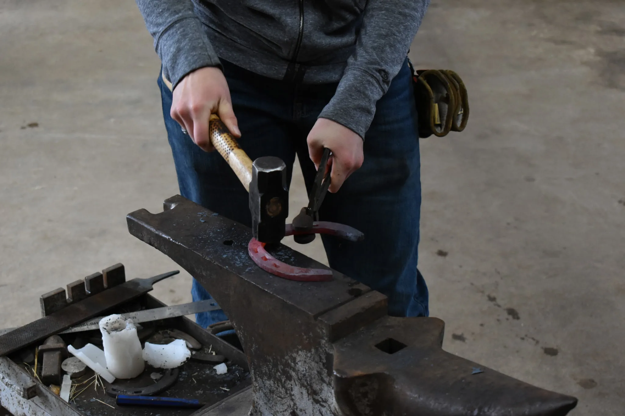 Hammering a red-hot shoe on the anvil